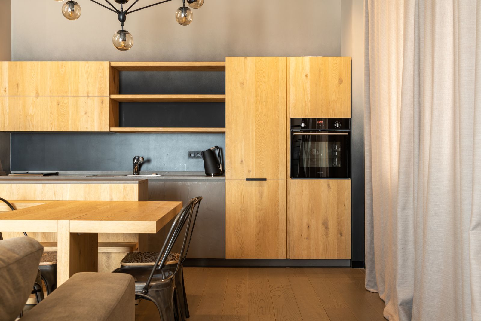 A renovated modern kitchen with new cabinetry and counters